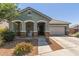 Charming exterior of a single-story home with stone accents, covered porch, and well-maintained landscaping at 23179 S 225Th Pl, Queen Creek, AZ 85142