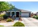 Charming single-story home featuring a well-maintained front yard and a two-car garage at 23179 S 225Th Pl, Queen Creek, AZ 85142