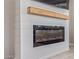Modern electric fireplace with shiplap wall and wooden mantel, creating a cozy focal point at 23179 S 225Th Pl, Queen Creek, AZ 85142