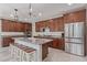 Well-equipped kitchen boasts granite countertops, wooden cabinets, stainless steel appliances, and a breakfast bar at 23179 S 225Th Pl, Queen Creek, AZ 85142