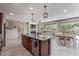 Spacious kitchen with stainless steel appliances, granite countertops, and seamless flow into the living and dining areas at 23179 S 225Th Pl, Queen Creek, AZ 85142