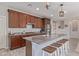 Beautiful kitchen features stainless steel appliances, wooden cabinets, granite countertops, and a convenient breakfast bar at 23179 S 225Th Pl, Queen Creek, AZ 85142