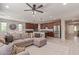 Spacious open-concept living area and kitchen with a neutral color scheme and stainless steel appliances at 23179 S 225Th Pl, Queen Creek, AZ 85142