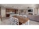 Open-concept living area featuring a spacious kitchen, dining table, and a comfortable Gathering room with a fireplace at 23179 S 225Th Pl, Queen Creek, AZ 85142