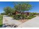 Park area with sidewalk, seating, pergola, restroom structure, and desert landscaping at 23179 S 225Th Pl, Queen Creek, AZ 85142