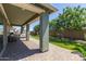 This covered patio features brick flooring, columns, a fan, recessed lights, and outdoor seating at 23179 S 225Th Pl, Queen Creek, AZ 85142
