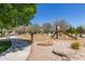 The neighborhood playground is equipped with mature trees and recreational equipment for outdoor fun at 23179 S 225Th Pl, Queen Creek, AZ 85142