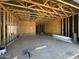 Interior view of a garage with wood framing and concrete floor ready for finishing at 2351 E Homesteader Rd, San Tan Valley, AZ 85140