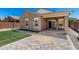 Well-maintained backyard featuring a covered patio, stone pavers, and lush landscaping perfect for outdoor living at 2368 E Bellerive Dr, Gilbert, AZ 85298