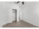 Bright bedroom features wood-look floors, ceiling fan, and closet with sliding doors at 2368 E Bellerive Dr, Gilbert, AZ 85298