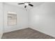 Well-lit bedroom features wood-look floors, a ceiling fan, and a window with blinds at 2368 E Bellerive Dr, Gilbert, AZ 85298