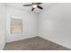 Well-lit bedroom features wood-look floors, a ceiling fan, and a window with blinds at 2368 E Bellerive Dr, Gilbert, AZ 85298