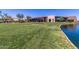 Elegant clubhouse overlooking a lush green lawn extending to the water's edge at 2368 E Bellerive Dr, Gilbert, AZ 85298