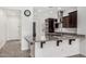Bright and modern kitchen with granite countertops, stainless steel appliances, breakfast bar, and dark wood cabinetry at 2368 E Bellerive Dr, Gilbert, AZ 85298