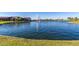Beautiful lake with a water fountain, complemented by lush green landscaping and a well-maintained shoreline at 2368 E Bellerive Dr, Gilbert, AZ 85298