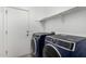 Laundry room with new front-load washer and dryer and convenient shelving at 2368 E Bellerive Dr, Gilbert, AZ 85298