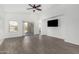 Bright living room with wood-style flooring, neutral walls, and access to the backyard through sliding glass doors at 2368 E Bellerive Dr, Gilbert, AZ 85298