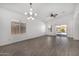 Spacious living room featuring wood-style floors, lots of natural light, and a modern chandelier at 2368 E Bellerive Dr, Gilbert, AZ 85298