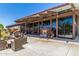 Inviting outdoor patio with comfortable seating and a cozy fireplace, perfect for relaxing or entertaining at 2368 E Bellerive Dr, Gilbert, AZ 85298