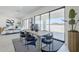 Bright dining room with a modern table and chairs, large windows, and contemporary decor at 24000 S 218Th Pl, Queen Creek, AZ 85142