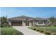Stunning single-story home with a well manicured lawn, modern design, and a spacious two-car garage at 24000 S 218Th Pl, Queen Creek, AZ 85142