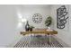 Modern home office setup with a wooden desk, decorative wall art, and minimalist decor at 24000 S 218Th Pl, Queen Creek, AZ 85142