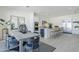 A stylish kitchen with dining area features modern appliances, an island with bar seating, and sleek countertops at 24000 S 218Th Pl, Queen Creek, AZ 85142