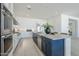 A modern kitchen featuring stainless steel appliances, a large island with a sink, and ample cabinet space at 24000 S 218Th Pl, Queen Creek, AZ 85142