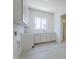 Bright laundry room with white cabinets, modern sink, and window for natural light at 24000 S 218Th Pl, Queen Creek, AZ 85142