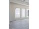 Living room showing the bright windows and light gray wood-look floors at 24000 S 218Th Pl, Queen Creek, AZ 85142