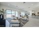Open-concept living room featuring stylish furniture, large windows, and plenty of natural light at 24000 S 218Th Pl, Queen Creek, AZ 85142