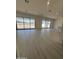 Spacious living room with abundant natural light and modern light wood flooring at 24000 S 218Th Pl, Queen Creek, AZ 85142