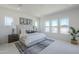 Spacious main bedroom with plush carpet, three large windows, and stylish decor at 24000 S 218Th Pl, Queen Creek, AZ 85142