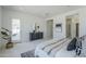 Bright main bedroom showcasing decor, closet access, and door to outdoor living area at 24000 S 218Th Pl, Queen Creek, AZ 85142