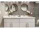 Well-lit bathroom featuring double sinks and stylish round mirrors at 26521 N Babbling Brook Dr, Phoenix, AZ 85083