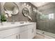 Modern bathroom with dual sinks, granite countertops, and a glass shower at 26521 N Babbling Brook Dr, Phoenix, AZ 85083