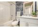 Well lit bathroom with subway tile walls, white vanity, and bathtub with shower at 26521 N Babbling Brook Dr, Phoenix, AZ 85083