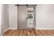 Bedroom showcases wood floors and a sliding door leading to a bathroom at 26521 N Babbling Brook Dr, Phoenix, AZ 85083