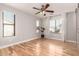 Spacious bedroom featuring wood floors, ceiling fan, and bright windows at 26521 N Babbling Brook Dr, Phoenix, AZ 85083