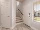 Bright and inviting foyer with wood-look tile flooring, staircase, and natural light at 26521 N Babbling Brook Dr, Phoenix, AZ 85083