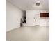 Clean garage interior with sealed floor, white door, and dark cabinetry at 26521 N Babbling Brook Dr, Phoenix, AZ 85083