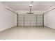 Spacious garage with a white door, epoxy floor, and bright overhead lighting at 26521 N Babbling Brook Dr, Phoenix, AZ 85083