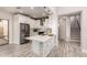 Open kitchen featuring white cabinetry, stainless steel appliances, and quartz countertops at 26521 N Babbling Brook Dr, Phoenix, AZ 85083
