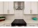 Contemporary kitchen with stainless steel range hood, white cabinetry and quartz countertop at 26521 N Babbling Brook Dr, Phoenix, AZ 85083