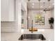 Open concept kitchen view with a stainless steel sink and modern pendant lighting above the island at 26521 N Babbling Brook Dr, Phoenix, AZ 85083