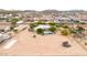 A captivating aerial shot of a desert home with a sparkling pool and large lot, enveloped by natural desert beauty at 27347 N Gary Rd, San Tan Valley, AZ 85144