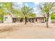 Rear view of the home featuring multiple entry points and a desert rock landscape at 27347 N Gary Rd, San Tan Valley, AZ 85144