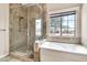 A bathroom with a separate shower and soaking tub with a window view at 27347 N Gary Rd, San Tan Valley, AZ 85144