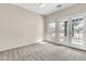 A neutral-toned bedroom with a ceiling fan and access to the backyard at 27347 N Gary Rd, San Tan Valley, AZ 85144