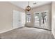 Bright bedroom with neutral carpet, French doors and decorative chandelier, creating a welcoming space at 27347 N Gary Rd, San Tan Valley, AZ 85144